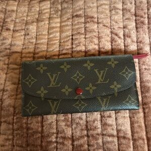 Louis Vuitton Wallet. Deep red interior, zipper tassel & closure snap.
